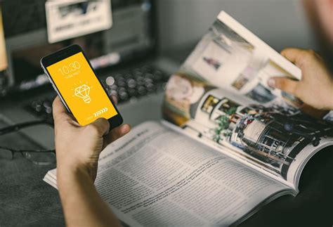 Go from idea to prototype to sharing faster. Man holding iPhone With magazine Mockup PSD | Download Mockup