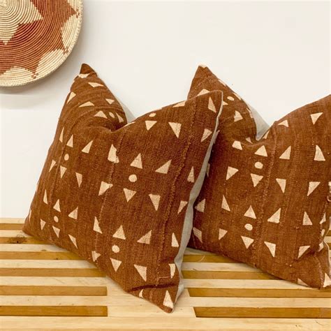 May 22, 2021 · this has a warming effect to the space! Rust mud cloth pillows just added to inventory! | African ...