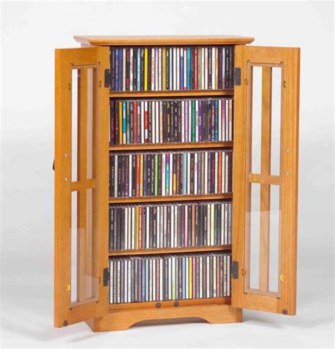 .multimedia dvd/cd storage cabinet with sliding glass doors walnut walnut finish brushed metal door pulls fully adjustable shelves allow for total versatility in storing dvds allow for total versatility in storing dvds videotapes and game cartridges tempered glass holds 700 cds or 336 dvds. 2-Door Media Wall Mount Cabinet W/ Glass Doors