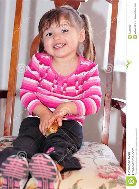 Cute toddler in funny conversation with mom. Cute Toddler Girl Happy About Her Baby Chick Stock Photo ...