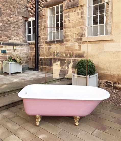 A modern oval bathtub matched with a satin nickel tub filler sits on. Rent This Pink, Alcohol-Filled Bathtub For Weddings ...