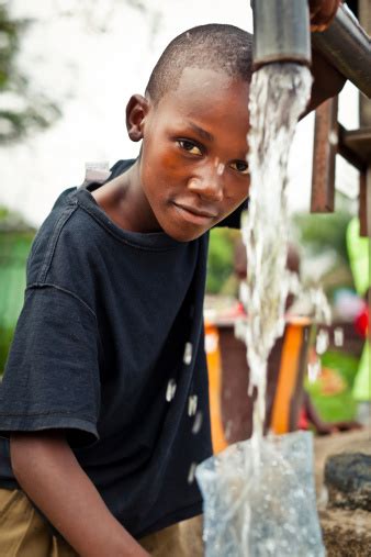 Authorities now want to free the giant container ship by a combination of removing containers, oil and water, multiple tug boats and dredging of sand. African Boy By Water Pump Stock Photo - Download Image Now ...