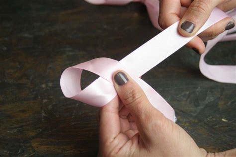 To tie a classic ribbon, make a loop at the center of a length of ribbon. How to Make a Bow Out of Ribbon | How to Tie a Perfect Bow | DIY Projects