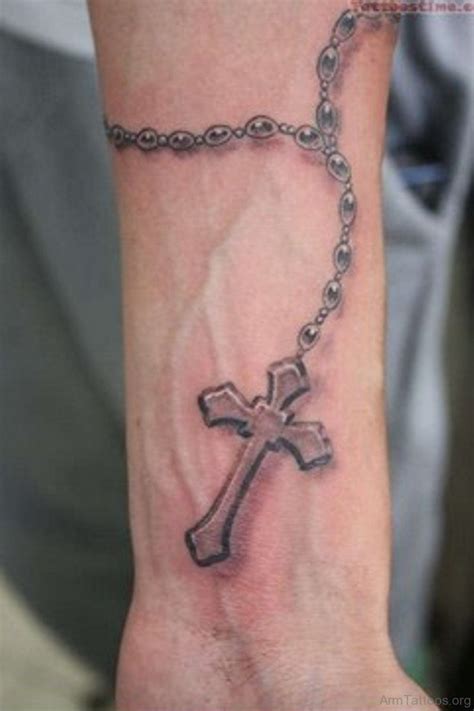 A rosary and a wooden cross by the rib cage. 75 Religious Rosary Tattoo On Arm