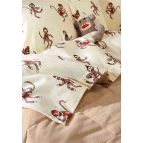 Flannel or cotton fabric can be made into cute sock monkey baby sheeting. Sock monkey cuddled into bed | Sock monkey, Monkey bedroom ...