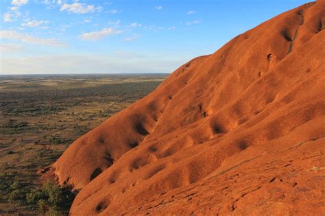Rising dramatically from the central australian desert, the huge red rock of uluru is one of australia's most iconic attractions. Mountains: Uluru (Ayers Rock), NT, Australia
