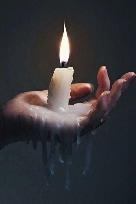 No matter how many candles are lit, the next step is to circle your hands across the top of the. Woman with a Burning candle in her palm & dripping wax ...