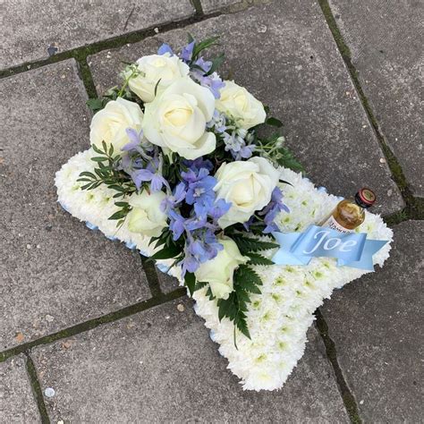 Beautiful blue and white flowers for a clients grandads funeral! Blue and white pillow funeral flowers tribute wreath with ...