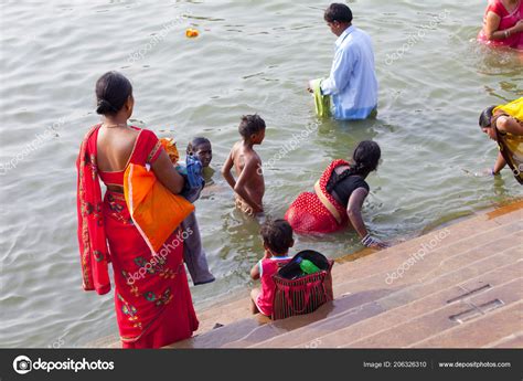 Since this ritual includes feeding the fishes, it is considered auspicious for the couple's journey. Varanasi Uttar Pradesh India July 2018 Pilgrims Bathing ...