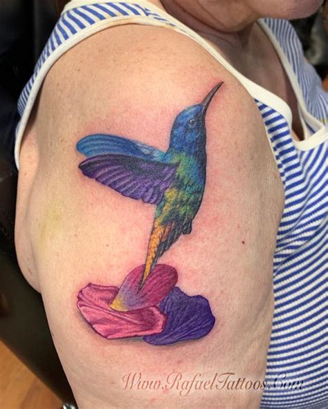 Maybe you would like to learn more about one of these? Realistic hummingbird with flower petals tattoo on aged ...