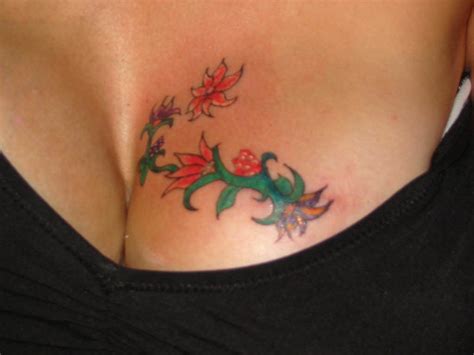 Getting flowery breast tattoos made is a perfect idea for women, especially if the main of the tattoo is aesthetic appeal. Rose Tattoo In Between Breast - Best Tattoo Ideas