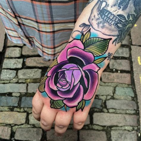 Purple rose, pink, yellow, white, and orange rose tattoo are generally tend to love and beauty meaning.; Traditional purple rose tattoo on the left hand.