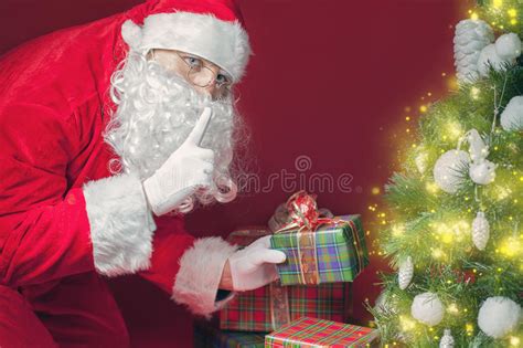 Maybe you would like to learn more about one of these? Santa Claus Putting Gift Box Or Present Under Christmas ...