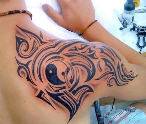 Most of these tattoos include dragons, dogs, circular rings, birds, and different types of motifs. Tribal Men Yin Yang Tattoo Idea | Shoulder blade tattoo ...