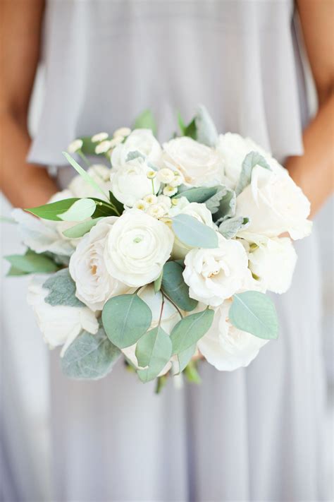 classic all white bridesmaids bouquet of white garden roses, white ranunculus, white spray 