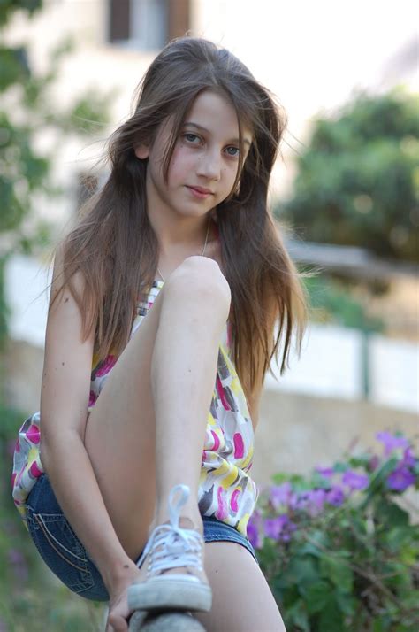 Portrait of a longing pensive teenager sitting on the beach looking away at the horizon in the morning. Angelina Teen Model: 29) FUN WITH ESCADA (1)