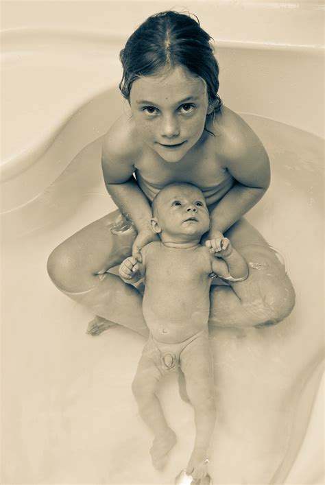 Lucie baptizes baby alice in the tummy tub. Bathing with baby brother | Frédéric De Vries | Flickr