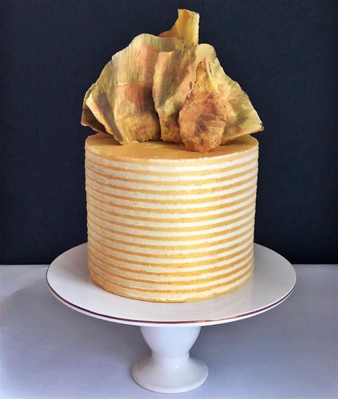 Cooked eggs enrich a thick layer of creamy chocolate mousse set between two layers of chocolate cake that's draped in ganache. Copper and gold striped birthday cake. Chocolate sail. New ...