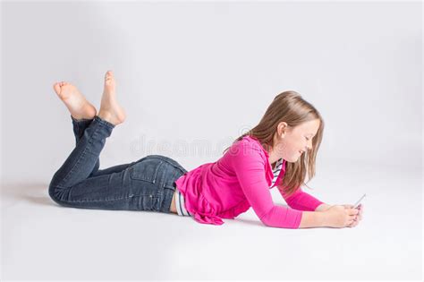 One then stands up while the other tries to cover her breasts. Pre-teen Girl Using Cellphone Stock Photo - Image of ...