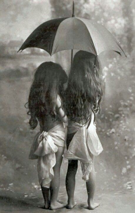 Listen and mark each statements as true, false or not stated. Two little girls enjoying the rain...keeping each other ...