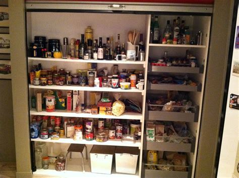 14 ways to make your pantry door stand out. Best pantry ever! Draws on right pull outward and red garage door pulls down over entire pantry ...