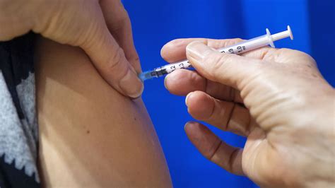 Two health service workers experienced symptoms after receiving pfizer vaccine. NHS Wales Starts Covid-19 Vaccination Campaign