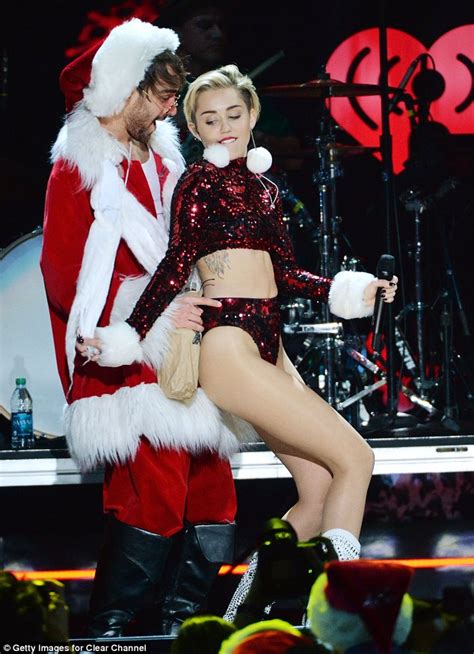 How do we know they're the hottest? Miley Cyrus dresses as 'Bad Santa' as she twerks for ...