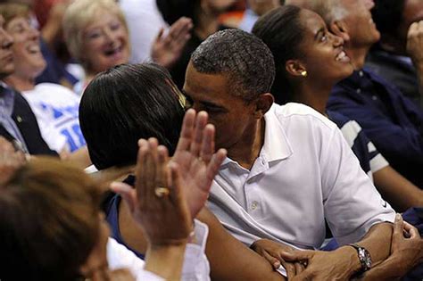 I wonder if they did that to not scare away the homphobic crowd. Obama and Michelle Kissing Photos at Basketball Game | Hot ...