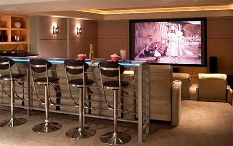 15 Interesting Media Rooms and Theaters With Bars | Home ... It features a widescreen tv and a large sofa set along with a bar on the back.