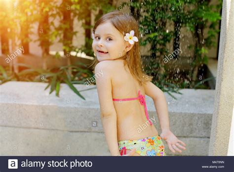 Blonde teen maya in the shower. kid taking shower, drops of water fall on little girl in ...