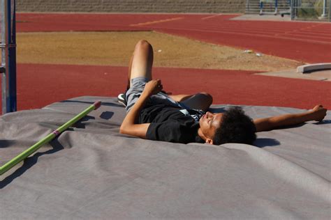 The athlete must jump over the bar (off one foot)which is set at measured heights. High jump competitors prepare for May 1 meet - Whitney Update