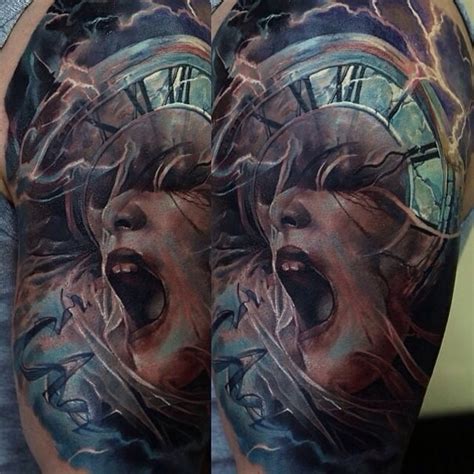 Woman screaming while getting a tattoo. Unusual colored horror style shoulder tattoo of screaming woman with old clock - Tattooimages.biz