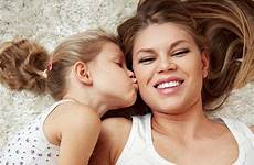 daughter kissing little pregnant mum