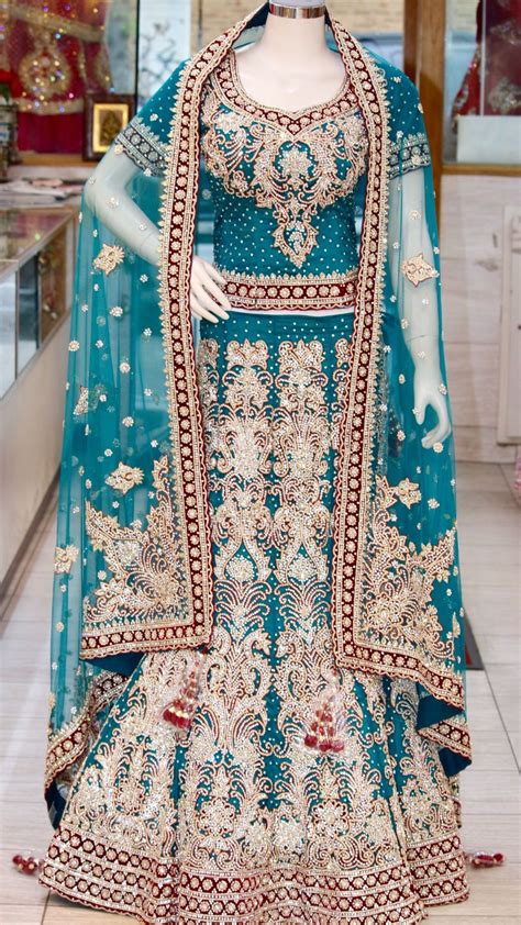 Seemly boot, suit and all white outfit ideas for ladies wish by. Teal and maroon bridal lehenga. This all over design is ...