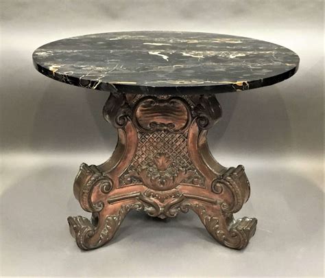 An italian neoclassical style center table with a black faux marble circular top with grey veining, on a nicely carved grey painred pedestal base, circa 1890. Italian copper and marble low centre table / coffee table ...