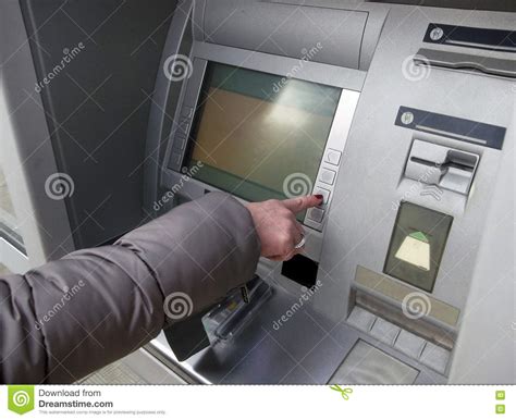 Close Up Of Hand Entering Pin At An ATM.Female Arms, ATM - Entering Pin.Woman Using Banking 