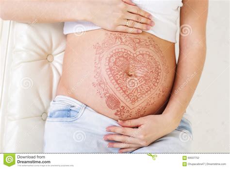 Sit back and enjoy the relaxing experience of having a custom henna design created just for you. Pregnant Belly With Mehendi Henna Tattoo Stock Photo ...