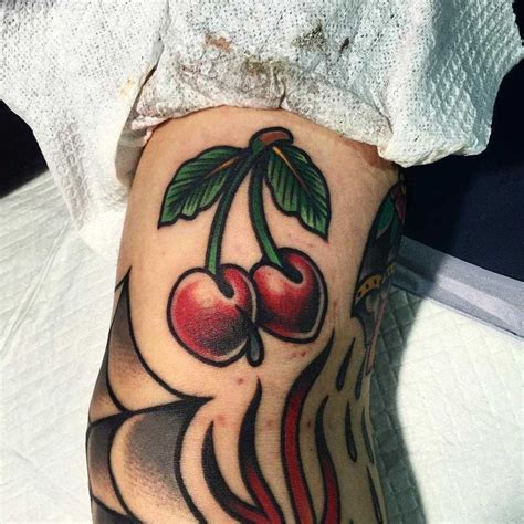 See more ideas about cherry tattoos, tattoos, tattoo designs. Traditional style cherries tattoo inked on an arm | Cherry ...