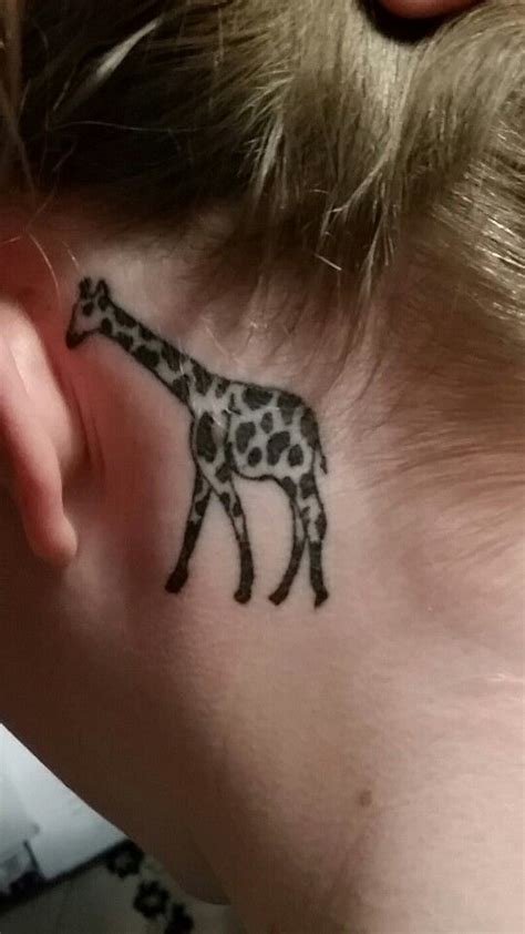 It can make a bold statement with bigger designs and bright colors. Giraffe tattoo behind ear - It has a cross inside ...