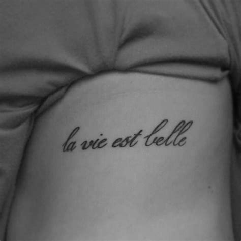 La vie est belle with flower tattoo. Side tattoo saying "La vie est belle" on Lisa. | Side ...