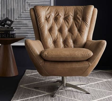 Rich leather creates a beautiful counterpoint to the exposed metal base. Wells Leather Swivel Armchair | Pottery Barn