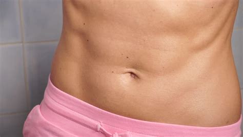 A photographic body image study. Stock Video Clip of Woman showing some strong abs and flat ...