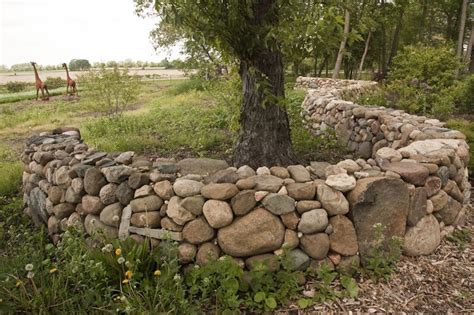 Protect yourself with stone walls but also give the outdoor place such a nice look. Northwind Perennial Farm rocks! | Stone landscaping, Rock ...