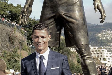 Portuguese footballer cristiano ronaldo stands near a bust of his likeness during a ceremony to rename. Cristiano Ronaldo inaugure sa statue de bronze