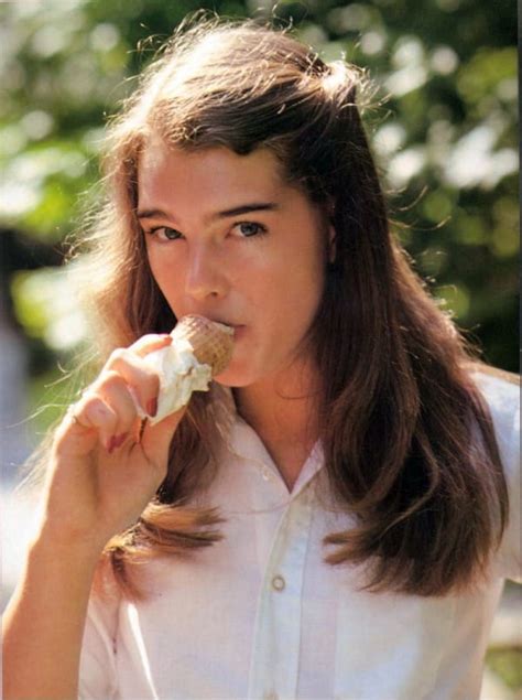 She is standing and sitting in a bathtub, wearing makeup, and covered in oil. Picture of Brooke Shields