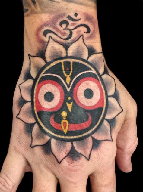 Egyptian god horus was cited as the god of the sky by ancient egyptians. The Hindu god Jagganatha and a small Om symbol tattoo, on ...