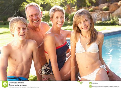 You may even find rentals with a pool that are pet friendly, so you can bring your pup along for the trip without having to sacrifice one of the best available amenities. Young Family Relaxing By Pool In Garden Stock Photo ...