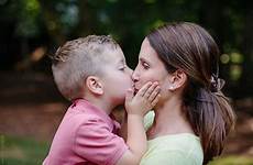 boy kiss young son mother mouth his giving cute