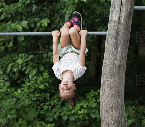 YOUNG GIRLS HANGING UPSIDE DOWN AT PLAYGROUND IN DRESSES SHOWING THEIR ...