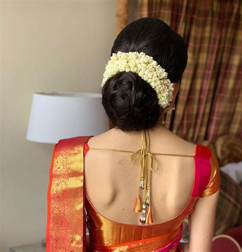 Many women prefer the bold and modern contemporary. What a beautiful large low bun with real flower gajra ...